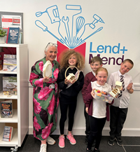 Lend and Mend Hub launch at South West Library, Greenock. Libraries team leader Alison Nolan with pupils from Lady Alice Primary.